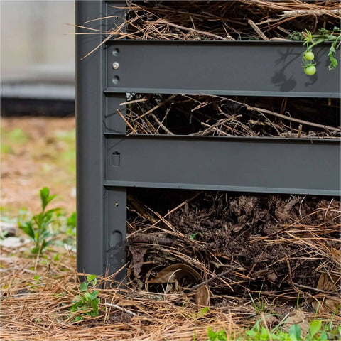 Close-up of a galvanized steel compost bin, showing modular design and removable slats for harvesting compost material.