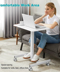 Woman using Go To Mobile Rolling Laptop Desk With Two Lockable Wheels Height Adjustable Sit Stand Computer Workstation on sofa