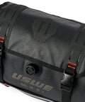 Close-up of waterproof bike handlebar bag rolltop 9L front frame storage with secure elastic straps and logo detail