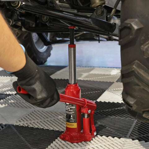 Torin BIG RED bottle jack, 2-ton capacity, under a vehicle with red hydraulic jack and chrome piston