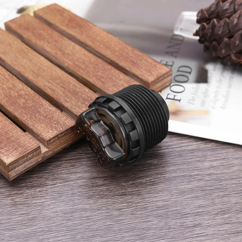 Black plastic 2 Pack Bicycle Front Fork Damping Rod Knob Lock Cap with 27.5mm threads and 30mm length on wooden surface