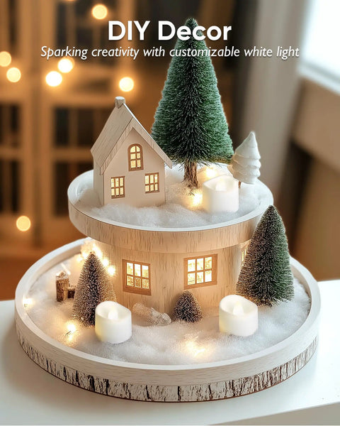 Decorative Christmas scene arrangement with mini house, pine trees, and warm Flameless Tealight Candles With Remote Timer Battery Operated 12 Pack Warm White