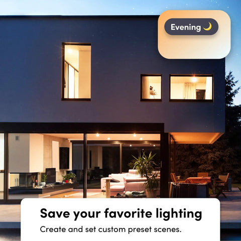 Wi-Fi Smart Infrared BR30 LED Bulb With 1100 Lumens illuminating modern house exterior at evening, visible through windows.