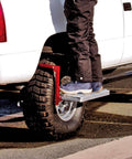 Person using Heavy Duty Tire Step For Trucks And SUVs, 300 Lb Capacity, Non Slip Cheese Grater Steel Surface on truck tire.