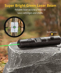 Rechargeable Bore Sight Laser Kit With 64 Adapters For Calibers From 0.17 To 12GA, green laser tool on stone with target view