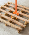 50 Inch All Steel Pallet Breaker With Non Slip Grip in use removing deck boards from a wooden pallet