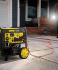 10,000-Watt Electric Start Home Backup Open Frame Portable Inverter Generator in use outside a house