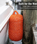 Orange Solid Nylon Boat Fenders For Docking And Marine Anti Collision Protection positioned on dock with boat