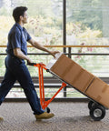 Person using 3 In 1 Convertible Hand Truck Aluminum Utility Dolly Cart with 880 lb capacity transporting boxes indoors