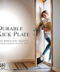 Woman entering home with Satin Black Door Kick Plate Anodized Aluminum Shield for Entry Doors 8x34 Inches Durable Protection.