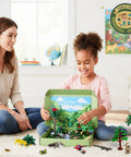 Child assembling Rainforest Diorama Kit With 33 Pieces PVC Animals And Insects, Miniature Trees, Moss, Sand And Stones, Display Box