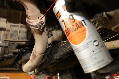 Applying Multipurpose Penetrating Lubricant Aerosol That Digs In Non Flammable Military Grade Rust Inhibitor to vehicle undercarriage