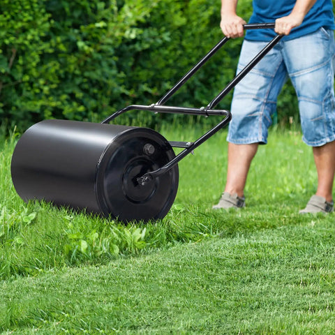 Man using Lawn Roller For Seed And Sod Preparation With 10 Gallon Water Fill Capacity And Welded Steel Drum Construction.