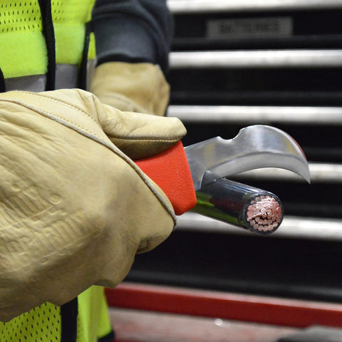 Worker using Orange Handle Hawkbill Cable Splicer Skinning Knife With Notched 3 Inch Blade For Easy Stripping Of Cable Jackets