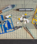 Premium Model Building Tool Kit For Gundam And Plastic Models on cutting mat with tools and model parts scattered