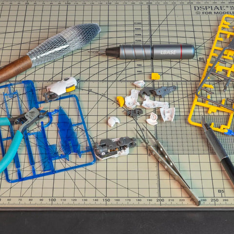 Premium Model Building Tool Kit For Gundam And Plastic Models on cutting mat with tools and model parts scattered