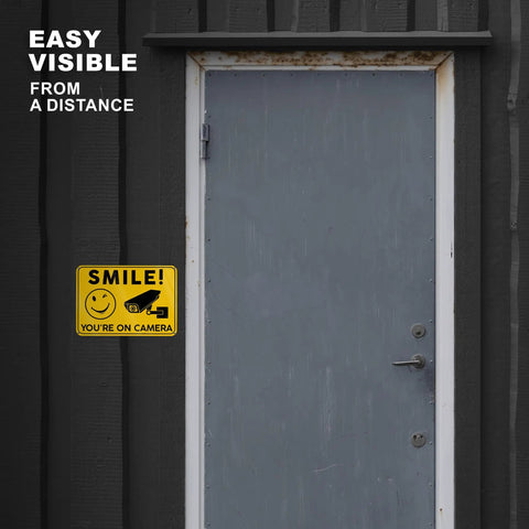 Smile Youre On Camera Signs 10x7 Outdoor Aluminum Notice Signs Single Sided Two Pack on dark exterior door, easy visible from a distance