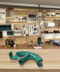 Manual Steel Pipe Bender For 3/4 Inch Copper Tube Conduit Bending Tool Head displayed on a wooden workbench with tools.
