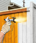 Pro Grade High Pressure Electric Airless Paint Sprayer Sports Thinning Free Design in action painting a wooden fence.
