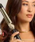 Woman holding 24K Gold Curling Iron With Extended 6 Inch Barrel For Tousled Curls Long Lasting Heat For Faster Styling Pro Grade Tool