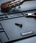 Black M2.5x18.5mm Tuner Peg Screws And Washers For Classical Guitar Machine Heads on workspace with tools and guitar.