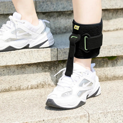 Adjustable Drop Foot AFO Brace for Unisex Use, Right Or Left Foot Ortho, Black ankle support shown on person wearing white sneakers.