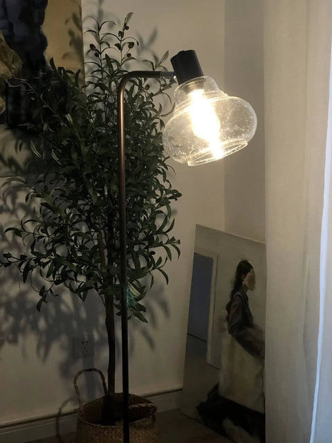 8 Inch Globe Pendant Light With Hand Blown Bubble Glass And Seeded Glass Details in a living room setting, black finish
