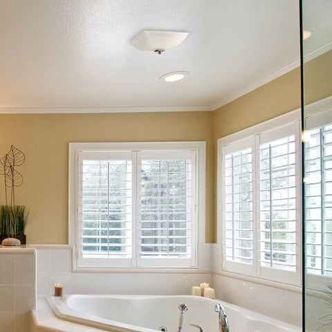 Decorative Square Ceiling Bath Fan With Light And Glass Globe 70 CFM Quiet 1.5 Sones For Bathrooms Up To 85 Sq Ft shown in a bathroom.