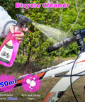 Person spraying a bike with a 750ml Bicycle Cleaner from the Bike Chain Cleaner Kit With Bicycle Cleaner Degreaser Lubricant And 12 Piece Cleaning Set For Mountain Road MTB And E Bikes Clean Degrease Lube Your Chain Like A Pro.