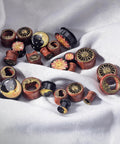 Six Piece Ear Plugs Set Sun Moon Natural Wood And Acrylic Tunnels Expander Plugs with Screw In Design on white fabric