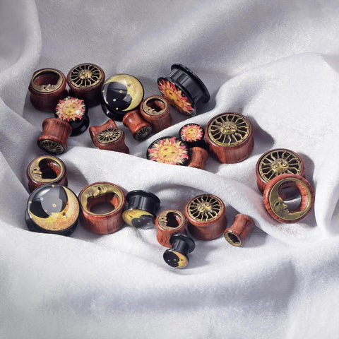 Six Piece Ear Plugs Set Sun Moon Natural Wood And Acrylic Tunnels Expander Plugs with Screw In Design on white fabric
