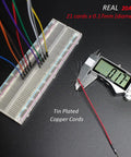 Caliper measuring copper cord from Real 20AWG Breadboard Jumpers Kit with 140 Assorted U Shape Wires, angled ESD tweezers visible