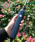 Close-up of a hand holding the lightweight plastic wand of the Go-To Electric Garden Sprayer for Easy Watering and Dosing