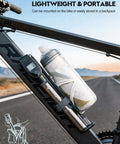 320 PSI High Pressure Bike Shock Pump with gauge mounted on a bike frame beside a water bottle, visible on an open road