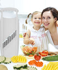Börner Wave-Waffle XXL PowerLine white crinkle-cut vegetable slicer on kitchen counter with assorted sliced vegetables.