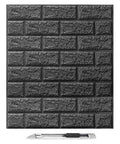 Black Faux Brick Peel And Stick Wall Panels with box cutter for scale, waterproof foam wallpaper for living rooms and bedrooms.