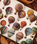 120 Colorful Hot Air Balloon PET Stickers Set for Scrapbooking and Journaling displayed in an open book