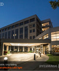 Exterior view of a modern building illuminated by Top Shelf LED HIDR Replacement Bulb 24 Watt A23 bollard fixtures.