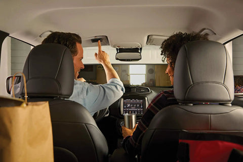 Couple inside car using 3 Button Garage Door Remote Compatible With Up To 3 Openers, In Vehicle Access LED indicator