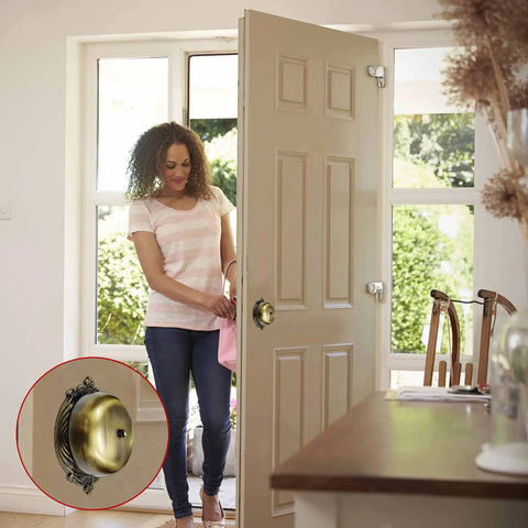 Woman entering home with Vintage Victorian Twist Bell With Key Plate Mechanical Doorbell visible on open door