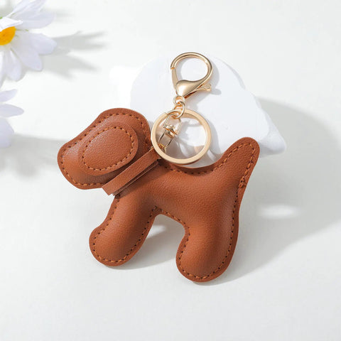 Premium Faux Leather Dog Bag Charm With Sturdy Metal Keyring for Trendy Handbags, featuring a cute brown dog design.