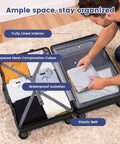 Open 20-inch black hard-shell carry-on luggage with spinner wheels; fully lined interior and clothes inside.