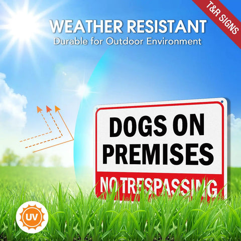 Built Solid 10x7 Inch Dogs On Premises No Trespassing Signs 2 Pack Rust Free Reflective Aluminum in grass under sunny sky.