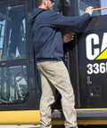 Worker wearing Digger 112 AF Safety Glasses with Yellow Lens next to construction equipment, in protective outfit.