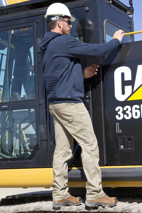 Worker wearing Digger 112 AF Safety Glasses with Yellow Lens next to construction equipment, in protective outfit.