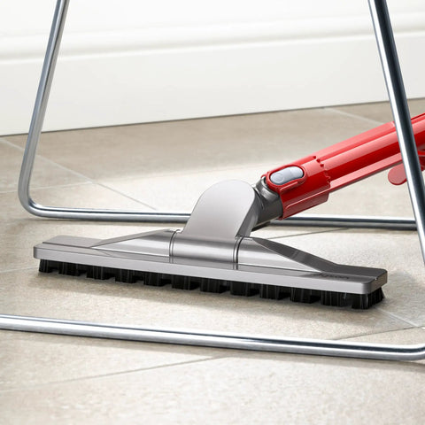 Articulating Hard Floor Tool with Swivel Brush Head cleaning under chair on a tiled floor