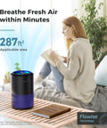 Air Purifier For Bedroom And Office With Sleep Mode And Speed Control, 360 Degree Filtration Cuts Smoke Pollen Dander Hair Odors, Quiet, Easy Setup, MK01 Black placed on table beside person