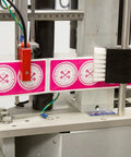 Heavy Duty Compact Modular Label Applicator shows labels aligned on a steel frame, designed for efficient factory use.
