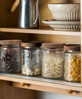 Airtight 24 oz glass storage jars with bamboo lids, vintage clear canister set on pantry shelf, perfect for sugar and cereals