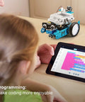 Child programs mBot robot on tablet; Three In One Servo Pack For mBot Upgrade Turns Your Bot Into A Dancing Cat, A Head Shaking Cat, Or A Light Emitting Cat With Easy To Follow Assembly Guide And Quick Setup Ideal For STEM Projects And Makers.